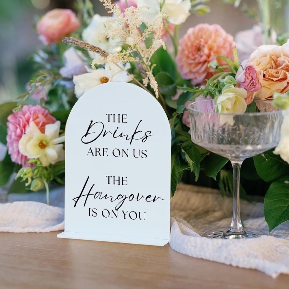 Black and white Wedding sign. The drinks are on us the hangover is on you